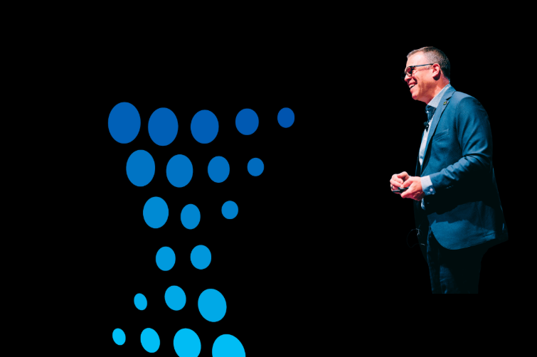 INNOVATE presenter in front of big screen